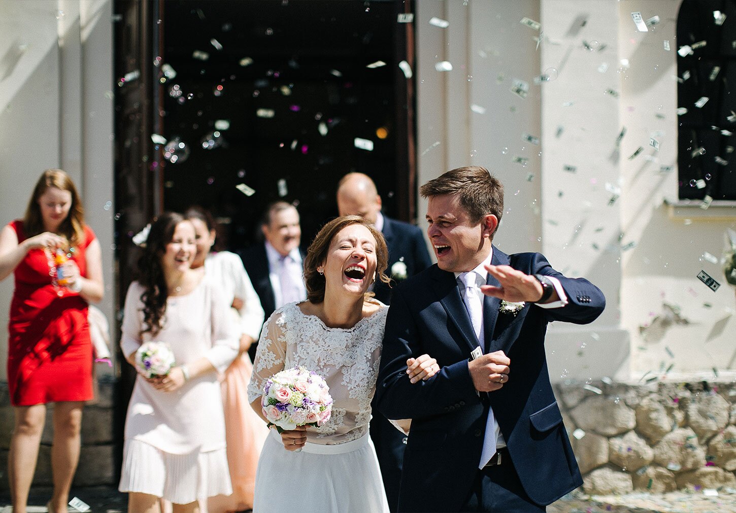 Photography of the newlyweds leaving the church after the ceremony