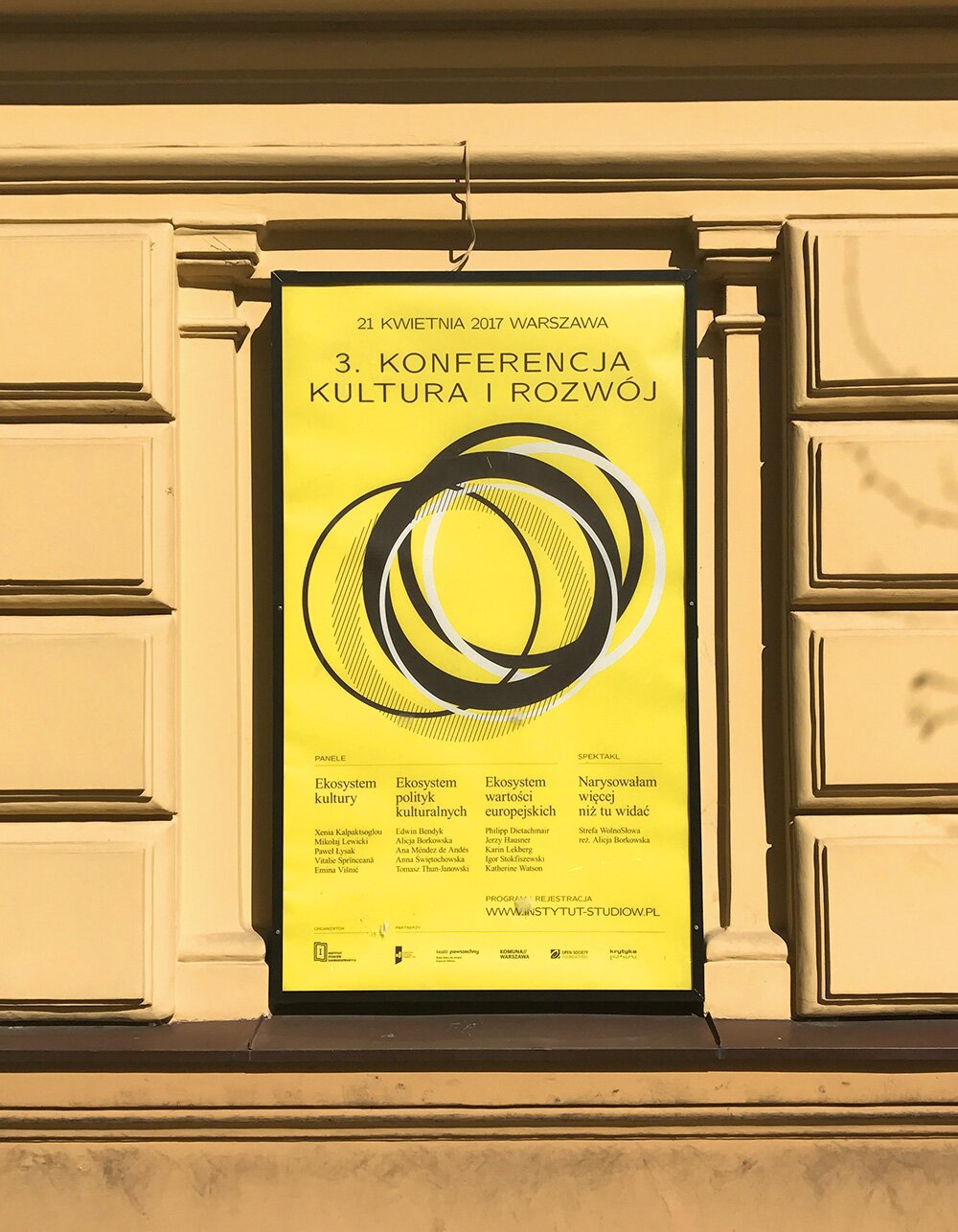 Poster for the conference hanging on the wall of the Political Critique's headquarters