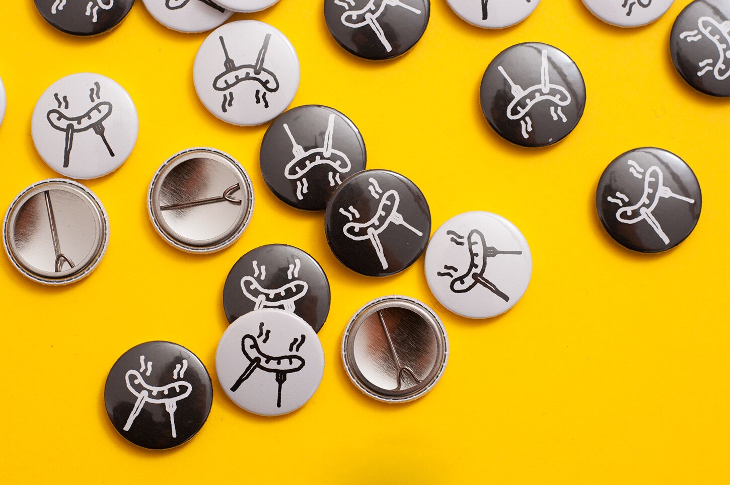 A photography of black and white pins with SMŻLN logo