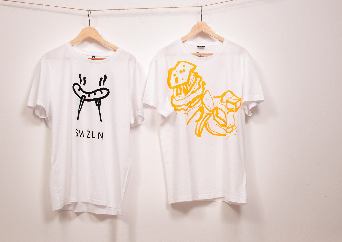 Two t-shirts with SMŻLN graphics