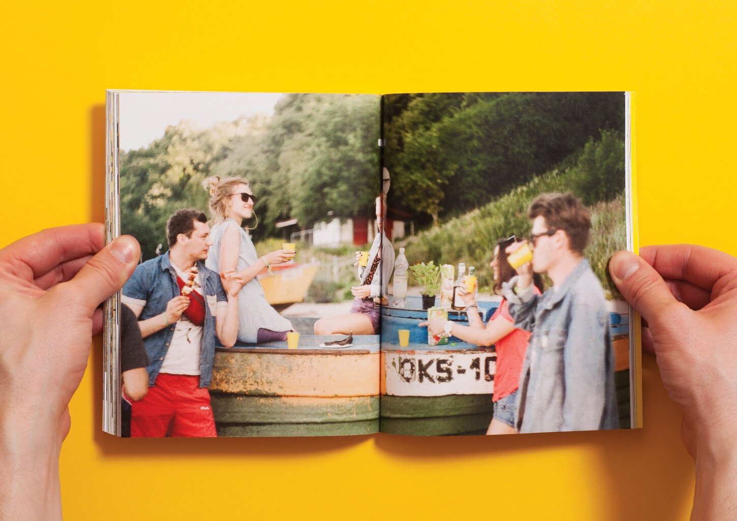 A spread from the UCZTA cookbook with a picture of people eating and drinking