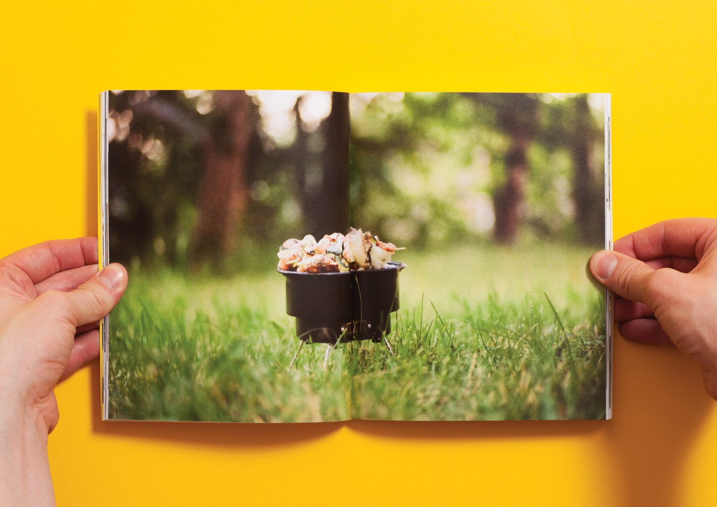 A spread from the UCZTA cookbook with a picture of food cooked on a grill